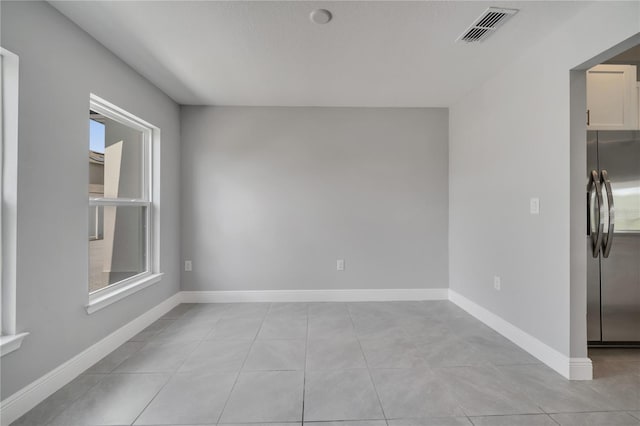 502 Viceroy Ct, Kissimmee, FL 34758 - spare room featuring light tile patterned floors and baseboards