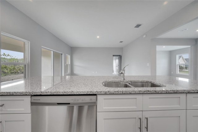 502 Viceroy Ct, Kissimmee, FL 34758 - kitchen featuring dishwasher, a sink, white cabinets, light stone countertops, and recessed lighting