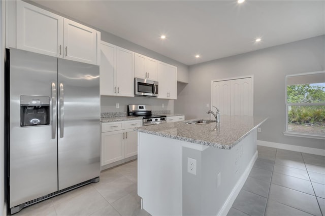 502 Viceroy Ct, Kissimmee, FL 34758 - kitchen with stainless steel appliances, a sink, light tile patterned floors, white cabinets, and recessed lighting
