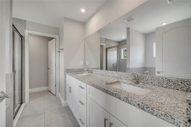 502 Viceroy Ct, Kissimmee, FL 34758 - full bath with a shower stall, double vanity, tile patterned floors, and baseboards