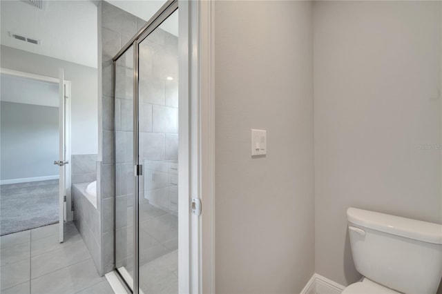 502 Viceroy Ct, Kissimmee, FL 34758 - bathroom featuring tile patterned floors, a stall shower, toilet, a bath, and baseboards