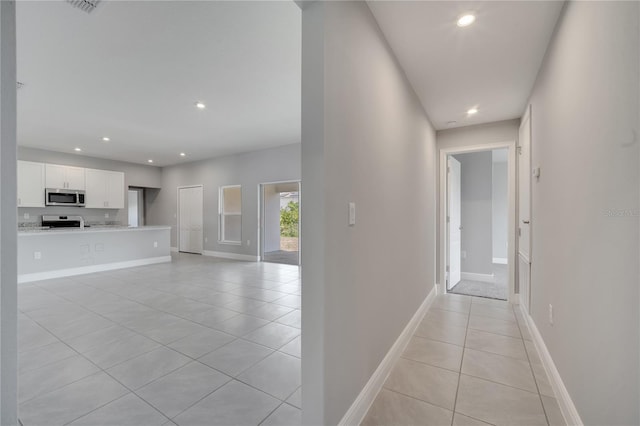 502 Viceroy Ct, Kissimmee, FL 34758 - hallway featuring light tile patterned floors, recessed lighting, and baseboards