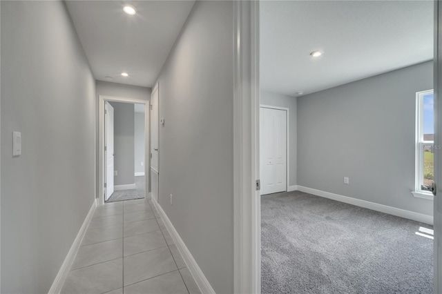 502 Viceroy Ct, Kissimmee, FL 34758 - corridor with recessed lighting, baseboards, light colored carpet, and light tile patterned floors