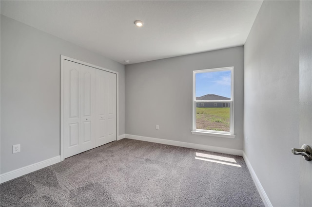 502 Viceroy Ct, Kissimmee, FL 34758 - unfurnished bedroom featuring carpet floors, baseboards, and a closet
