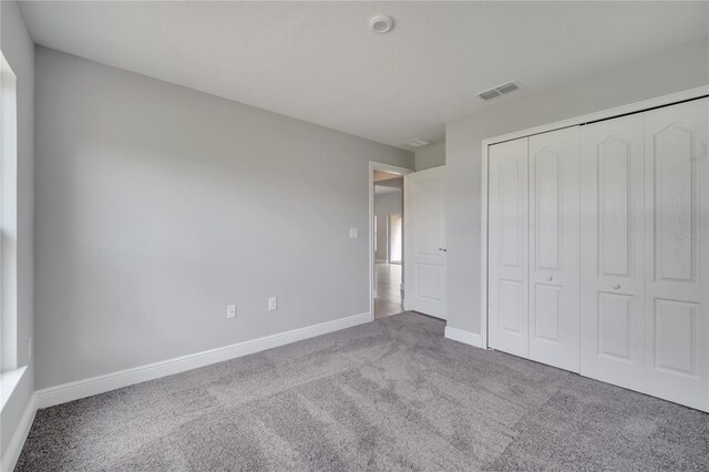 502 Viceroy Ct, Kissimmee, FL 34758 - unfurnished bedroom featuring carpet flooring, baseboards, and a closet