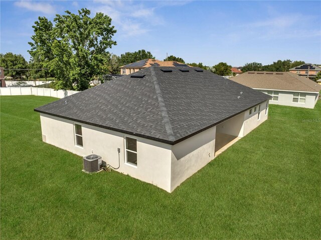 502 Viceroy Ct, Kissimmee, FL 34758 - back of house featuring roof with shingles, stucco siding, and central AC