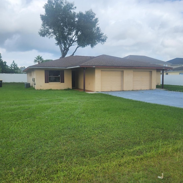 366-368 Dundee Dr, Kissimmee, FL 34759 - view of front of home featuring a garage, driveway, stucco siding, and central AC unit