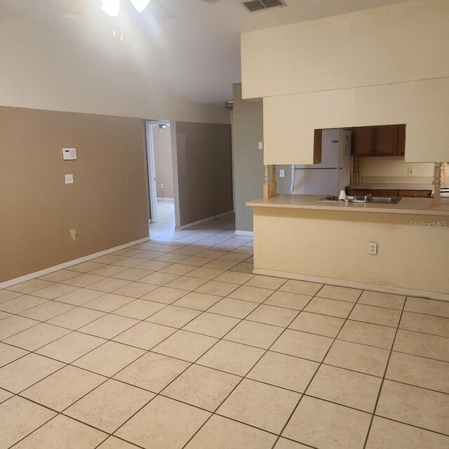366-368 Dundee Dr, Kissimmee, FL 34759 - kitchen with light countertops, baseboards, lofted ceiling, a peninsula, and a sink