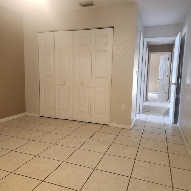 366-368 Dundee Dr, Kissimmee, FL 34759 - unfurnished bedroom featuring light tile patterned flooring, a closet, and baseboards