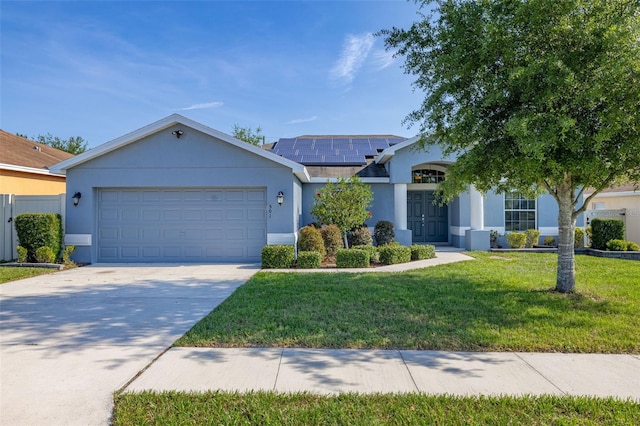 501 Pheasant Dr, Haines City, FL 33844 - single story home featuring a front yard, solar panels, an attached garage, concrete driveway, and stucco siding