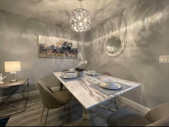 2798 Club Cortile Cir Unit A, Kissimmee, FL 34746 - dining area featuring baseboards, a chandelier, and wood finished floors