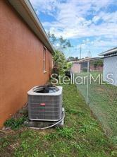 1107 Dartford Dr, Kissimmee, FL 34758 - exterior view of central AC and stucco siding