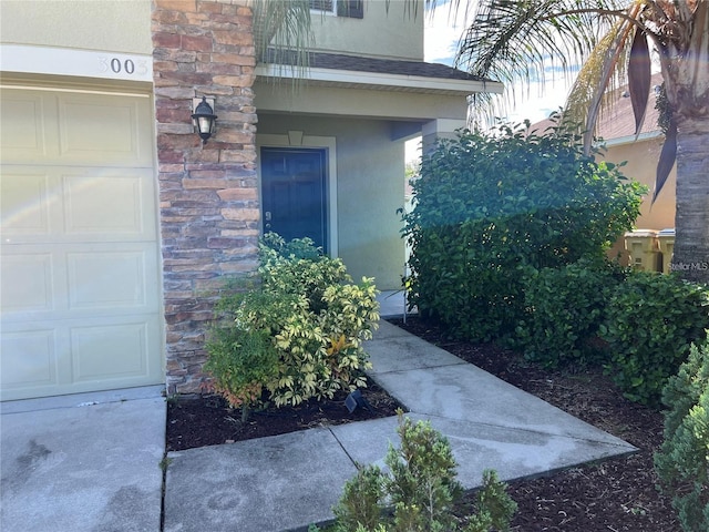 3003 Cobham Rd, Kissimmee, FL 34758 - property entrance with stucco siding, a garage, and stone siding