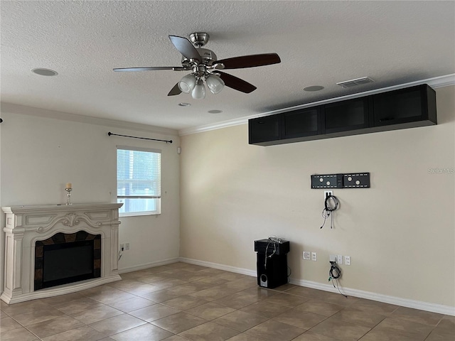 3003 Cobham Rd, Kissimmee, FL 34758 - unfurnished living room featuring tile patterned flooring, ceiling fan, a fireplace, crown molding, and a textured ceiling