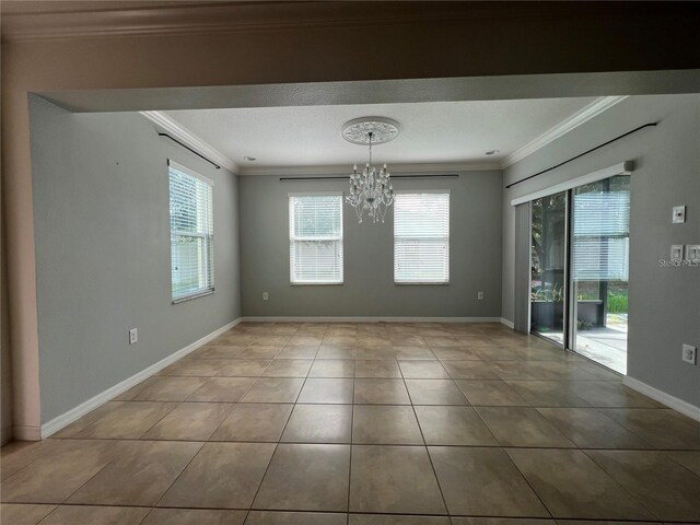 3003 Cobham Rd, Kissimmee, FL 34758 - tiled spare room featuring ornamental molding, a chandelier, and baseboards