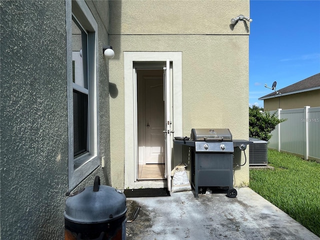3003 Cobham Rd, Kissimmee, FL 34758 - view of patio featuring fence, grilling area, and central AC unit