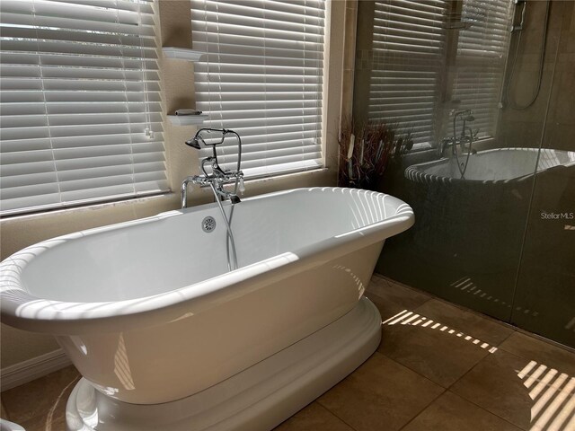 3003 Cobham Rd, Kissimmee, FL 34758 - full bath with tile patterned flooring, a freestanding bath, and a shower