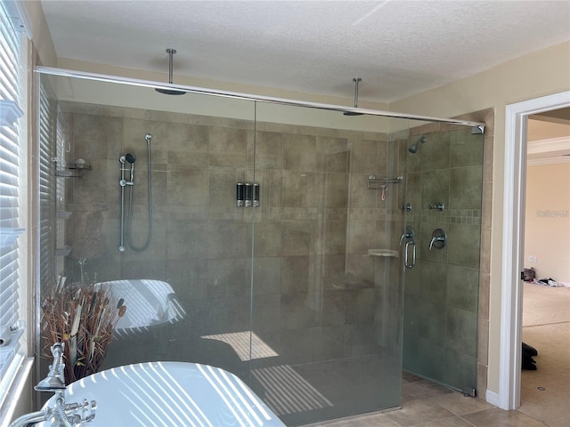 3003 Cobham Rd, Kissimmee, FL 34758 - bathroom featuring a shower stall, tile patterned flooring, and a textured ceiling
