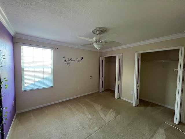 3003 Cobham Rd, Kissimmee, FL 34758 - unfurnished bedroom featuring two closets, crown molding, carpet, a ceiling fan, and baseboards