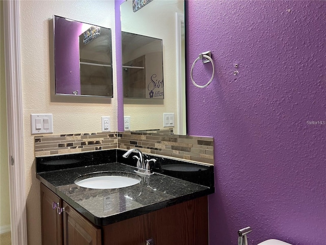 3003 Cobham Rd, Kissimmee, FL 34758 - bathroom featuring decorative backsplash, a textured wall, and vanity