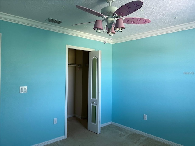 3003 Cobham Rd, Kissimmee, FL 34758 - unfurnished bedroom with a textured ceiling, carpet, a closet, baseboards, and crown molding