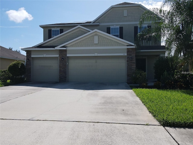 3003 Cobham Rd, Kissimmee, FL 34758 - craftsman-style house with driveway, stone siding, and an attached garage