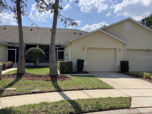 88 Club Villas Ln, Kissimmee, FL 34744 - ranch-style house featuring a garage, driveway, a shingled roof, stucco siding, and a front yard