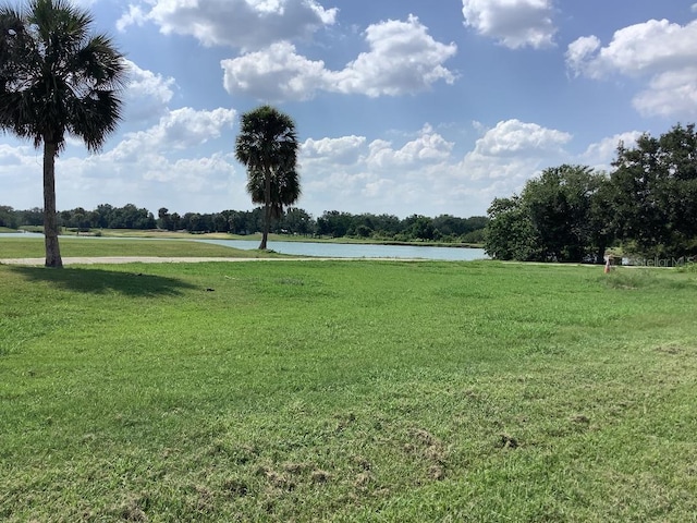 88 Club Villas Ln, Kissimmee, FL 34744 - view of community featuring a water view and a lawn