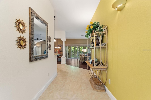 1258 Donalds Pl, The Villages, FL 32162 - hallway with ornate columns, baseboards, and tile patterned floors