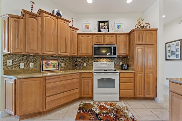 1258 Donalds Pl, The Villages, FL 32162 - kitchen featuring stainless steel microwave, white electric stove, backsplash, light stone countertops, and light tile patterned floors