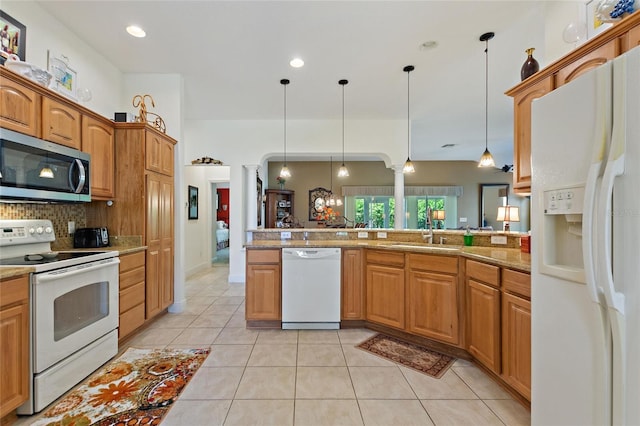 1258 Donalds Pl, The Villages, FL 32162 - kitchen with white appliances, a sink, tasteful backsplash, hanging light fixtures, and decorative columns