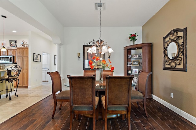 1258 Donalds Pl, The Villages, FL 32162 - dining area with a chandelier, light wood-style flooring, baseboards, ornate columns, and recessed lighting