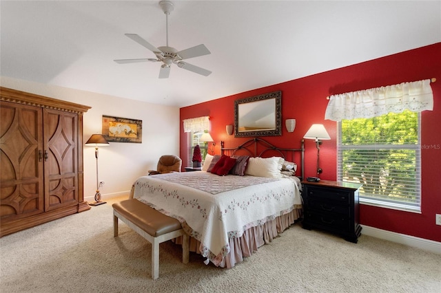 1258 Donalds Pl, The Villages, FL 32162 - bedroom with light colored carpet, baseboards, vaulted ceiling, and a ceiling fan
