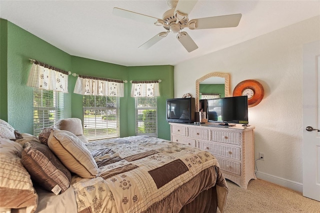 1258 Donalds Pl, The Villages, FL 32162 - bedroom with multiple windows, carpet, baseboards, ceiling fan, and a textured wall