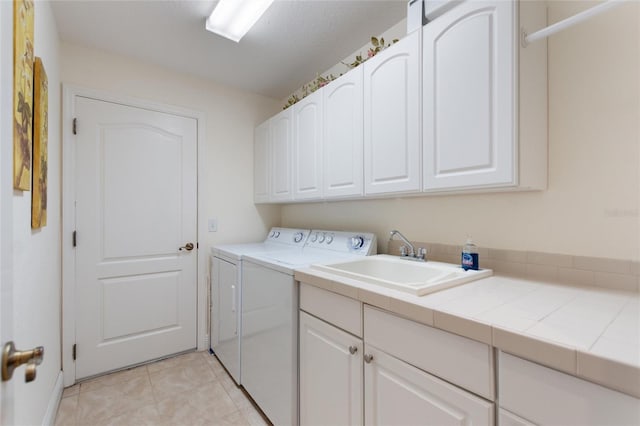 1258 Donalds Pl, The Villages, FL 32162 - laundry area featuring cabinet space, washing machine and clothes dryer, and light tile patterned flooring