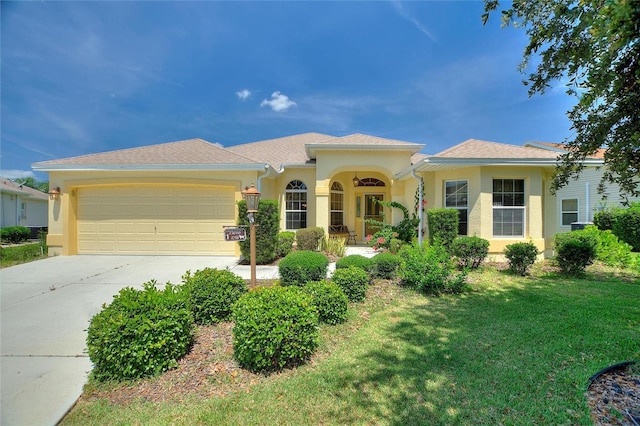 1258 Donalds Pl, The Villages, FL 32162 - view of front of property featuring driveway, a garage, a front yard, and stucco siding