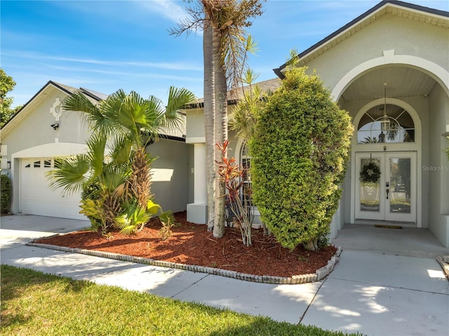 3211 Countryside View Dr, Saint Cloud, FL 34772 - view of front of home featuring stucco siding, french doors, an attached garage, and concrete driveway
