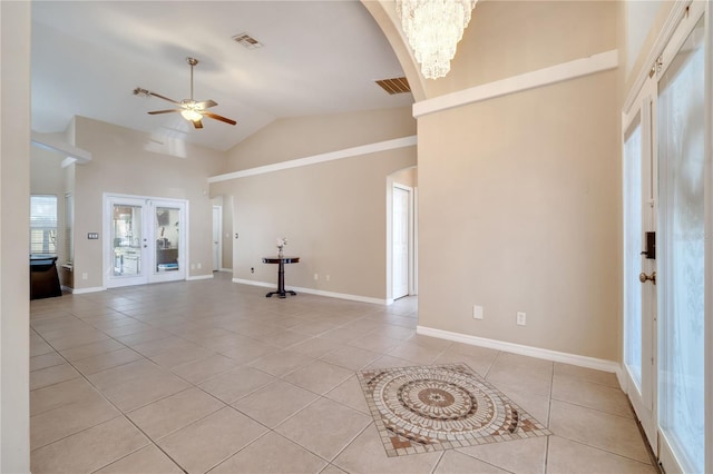 3211 Countryside View Dr, Saint Cloud, FL 34772 - unfurnished living room with light tile patterned floors, ceiling fan, arched walkways, baseboards, and high vaulted ceiling
