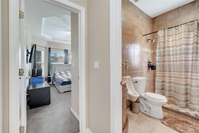 3211 Countryside View Dr, Saint Cloud, FL 34772 - bathroom featuring toilet, a shower with curtain, ensuite bath, tile walls, and a raised ceiling