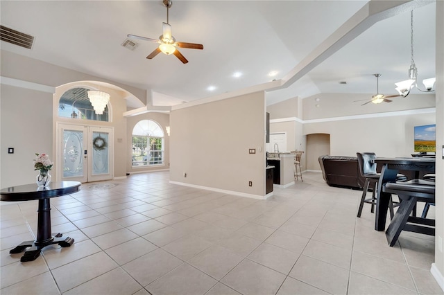 3211 Countryside View Dr, Saint Cloud, FL 34772 - entrance foyer featuring a ceiling fan, arched walkways, a chandelier, lofted ceiling, and light tile patterned flooring