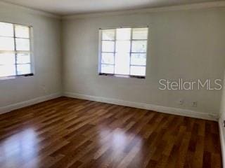 1309 N Thacker Ave, Kissimmee, FL 34741 - spare room featuring crown molding, baseboards, and wood finished floors