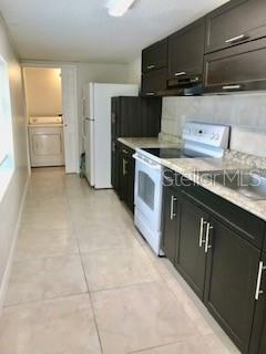1309 N Thacker Ave, Kissimmee, FL 34741 - kitchen featuring white range with electric cooktop, washer / dryer, light countertops, and dark cabinets