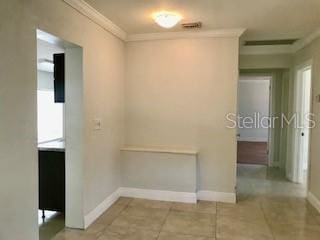 1309 N Thacker Ave, Kissimmee, FL 34741 - corridor featuring baseboards, tile patterned flooring, and crown molding