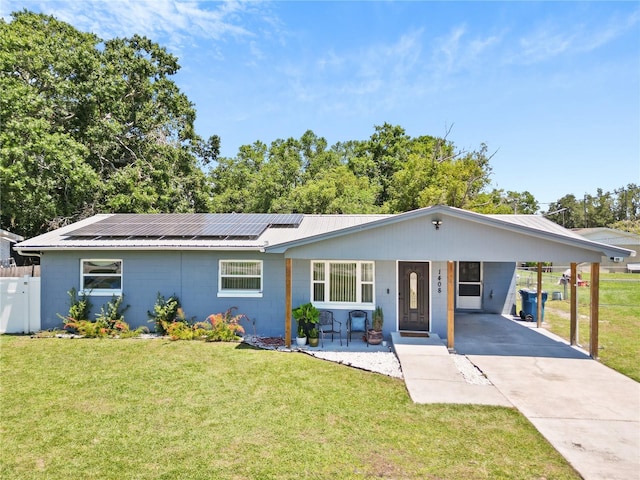 1408 Polk City Rd, Haines City, FL 33844 - ranch-style house with concrete block siding, driveway, a carport, and roof mounted solar panels