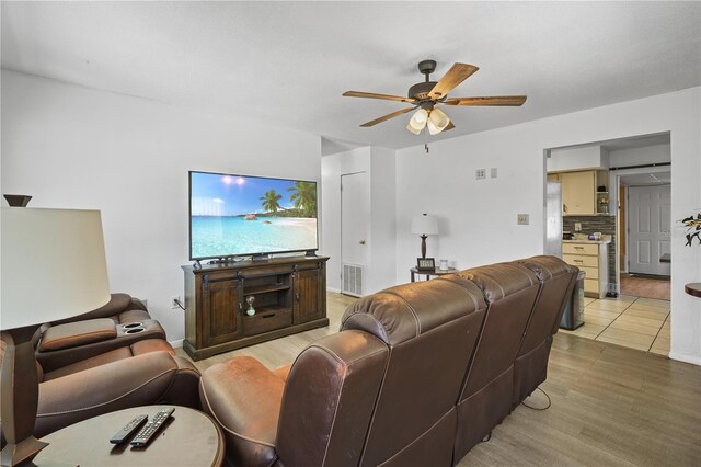 1408 Polk City Rd, Haines City, FL 33844 - living room with a ceiling fan and light wood-style flooring