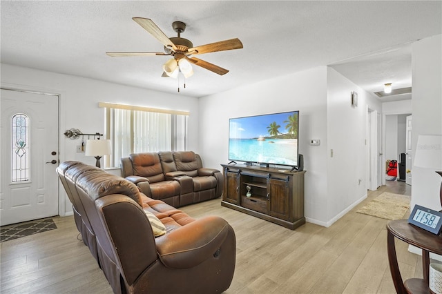 1408 Polk City Rd, Haines City, FL 33844 - living room with light wood finished floors, plenty of natural light, a ceiling fan, and baseboards