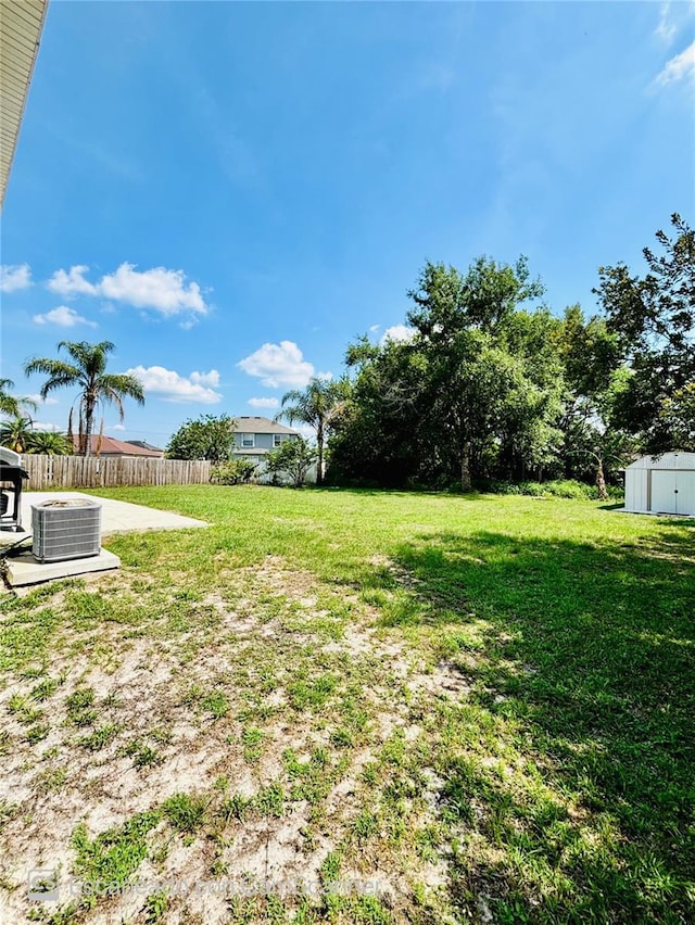 467 Martigues Dr, Kissimmee, FL 34759 - view of yard with cooling unit, a storage unit, and an outbuilding