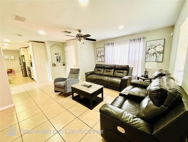 467 Martigues Dr, Kissimmee, FL 34759 - living room featuring light tile patterned floors, ceiling fan, plenty of natural light, and baseboards