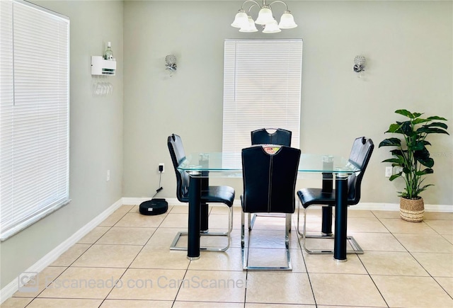467 Martigues Dr, Kissimmee, FL 34759 - dining room with light tile patterned floors, a chandelier, and baseboards