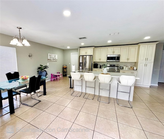 467 Martigues Dr, Kissimmee, FL 34759 - kitchen featuring appliances with stainless steel finishes, light tile patterned flooring, a chandelier, recessed lighting, and light countertops